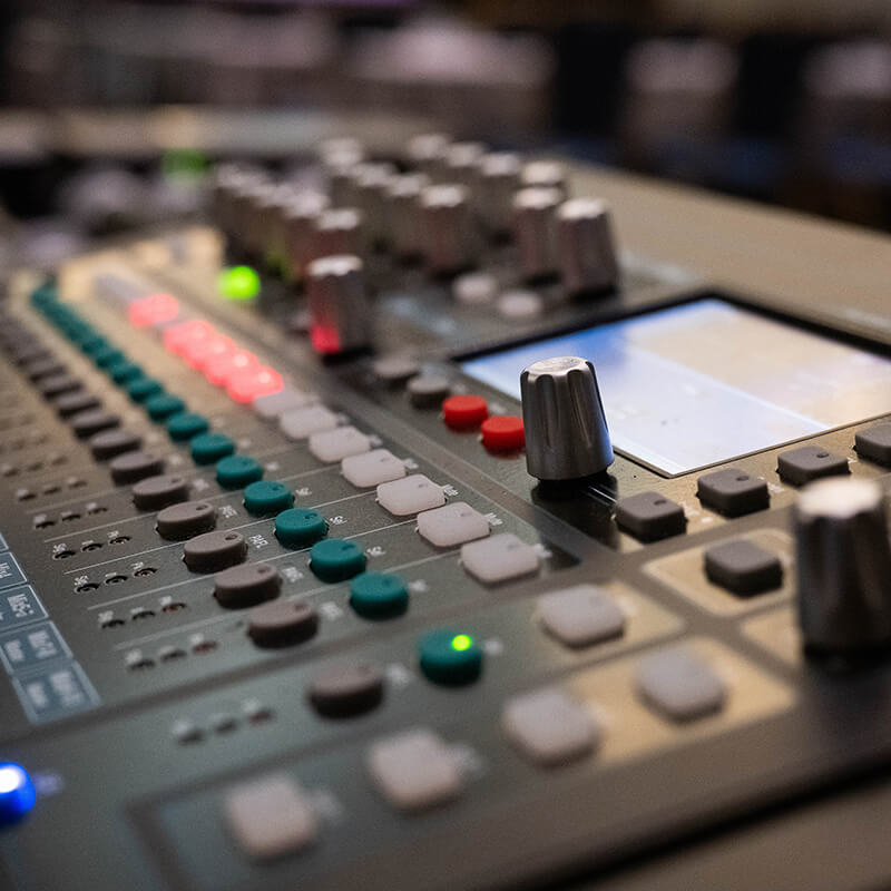 Audio/visual control board with many colorful buttons and knobs